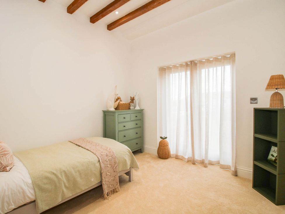 A bedroom with a bed and dresser at The Hayloft in Birmingham