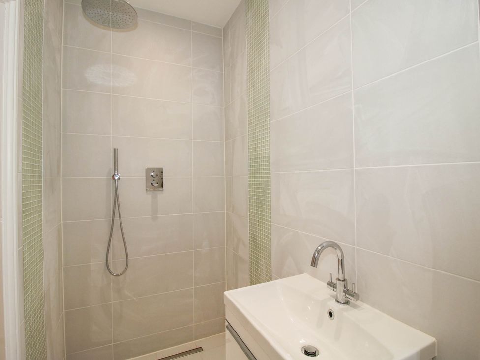 A bathroom with a shower and sink at The Hayloft in Birmingham