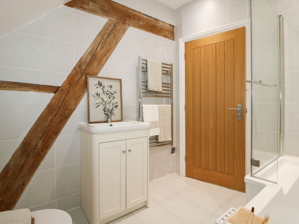 A bathroom with a sink, cabinet, and towel rack at The Hayloft in Birmingham