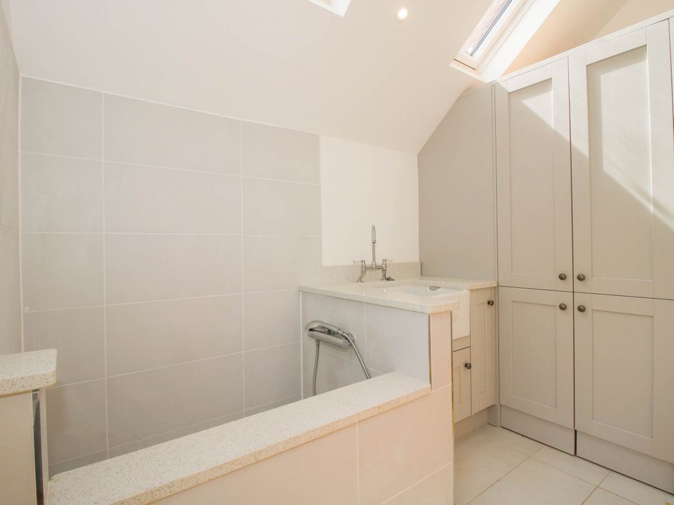 A bathroom with a bathtub and sink at The Hayloft in Birmingham