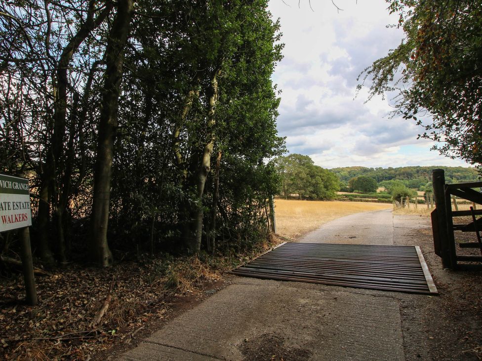 A pathway leading to a field with a sign at The Hayloft in Birmingham