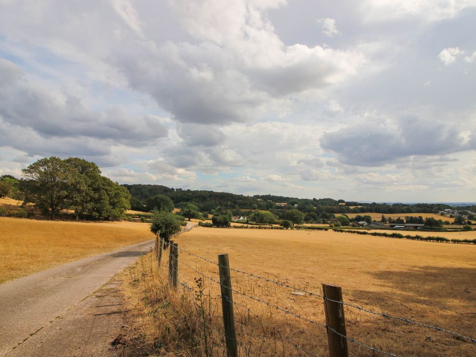 A field with a road and trees at The Hayloft in Birmingham