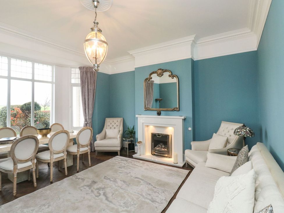 A dining room with a table and chairs at Russell House in Paignton