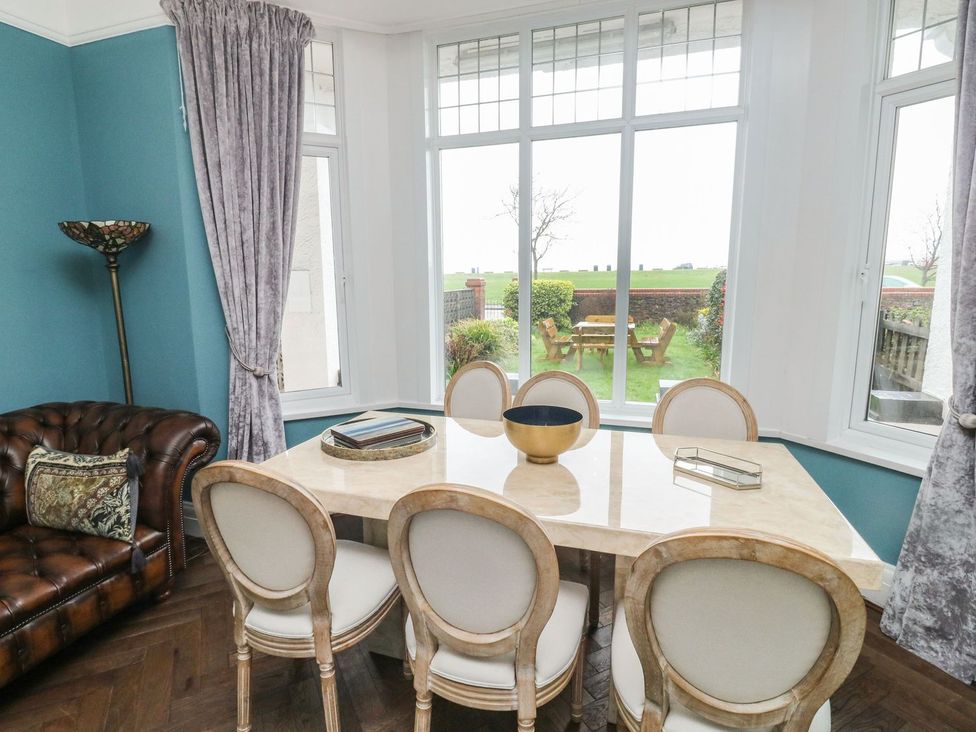 A dining room with a table and chairs at Russell House in Paignton