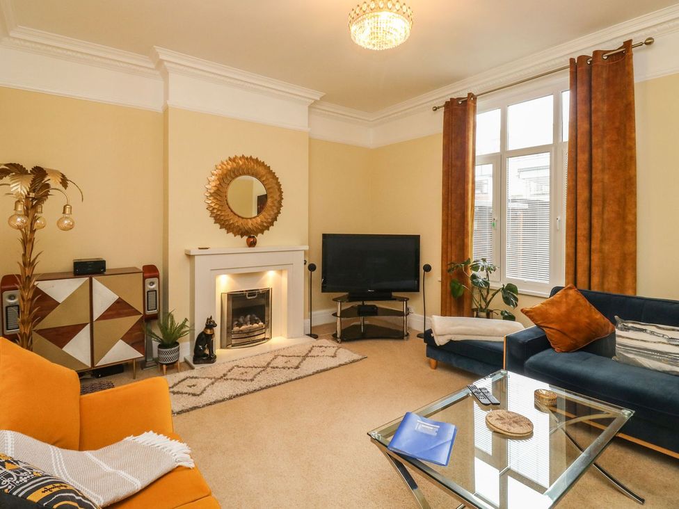 A living room with a television and coffee table at Russell House in Paignton