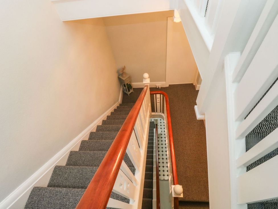 A staircase with a handrail and carpet at Russell House in Paignton