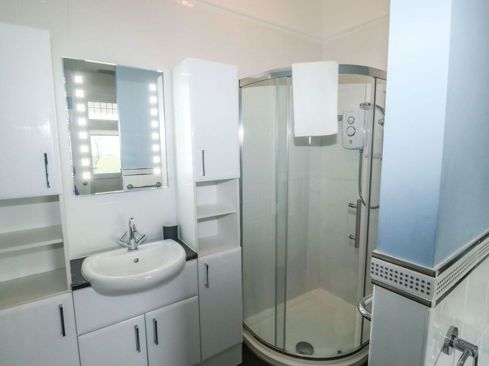 A bathroom with a shower and sink at Russell House in Paignton