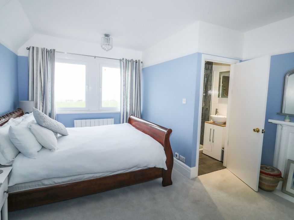 A bedroom with a bed and a connected bathroom at Russell House in Paignton