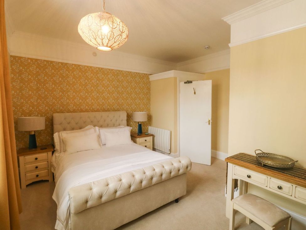 A bedroom with a bed and nightstand at Russell House in Paignton
