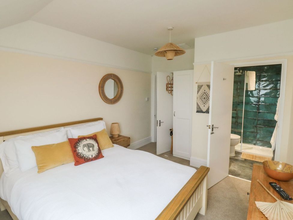 A bedroom with a bed and attached bathroom at Russell House in Paignton