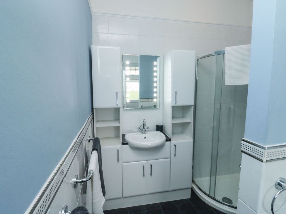 A bathroom with a sink and shower at Russell House in Paignton