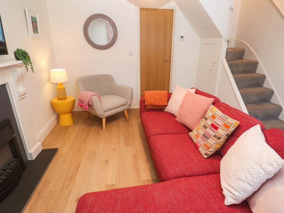 A living room with a sofa and armchair at Top Deck in St. Ives