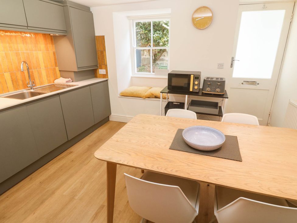 A kitchen with appliances and a table at Top Deck in St. Ives