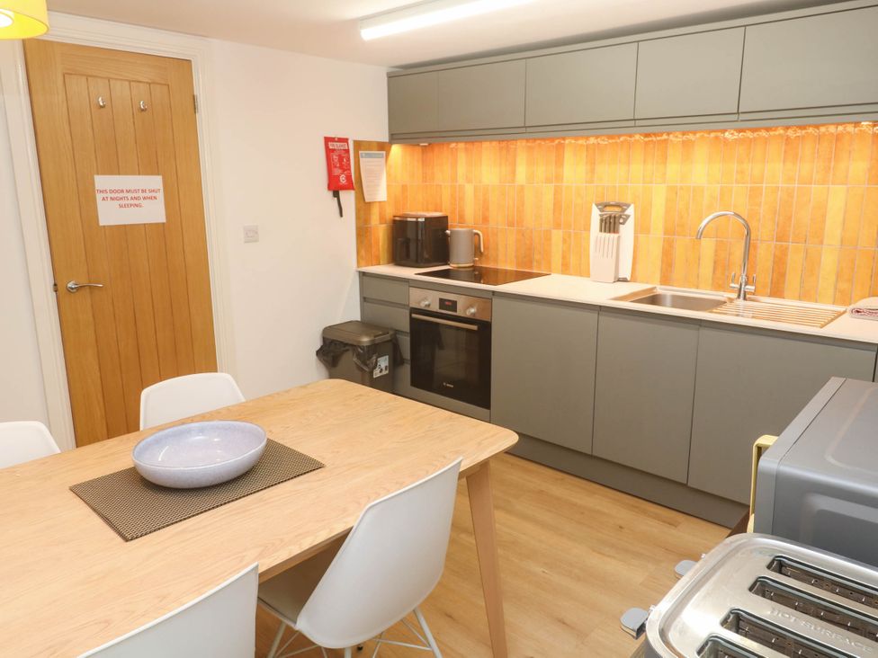 A kitchen with a table and chairs at Top Deck in St. Ives