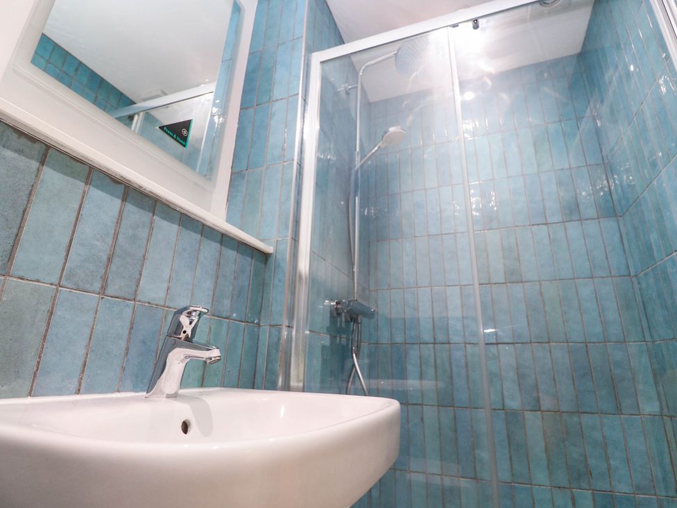 A bathroom with a sink and shower at Top Deck in St. Ives