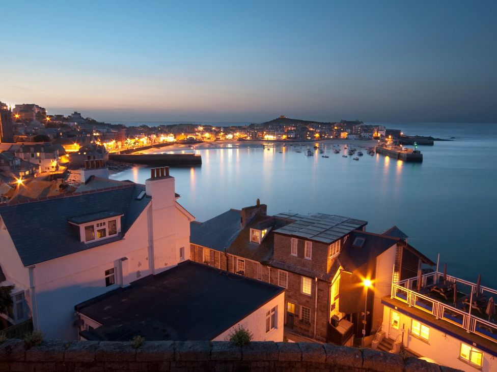 A view of a harbor with boats and houses at Top Deck in St Ives