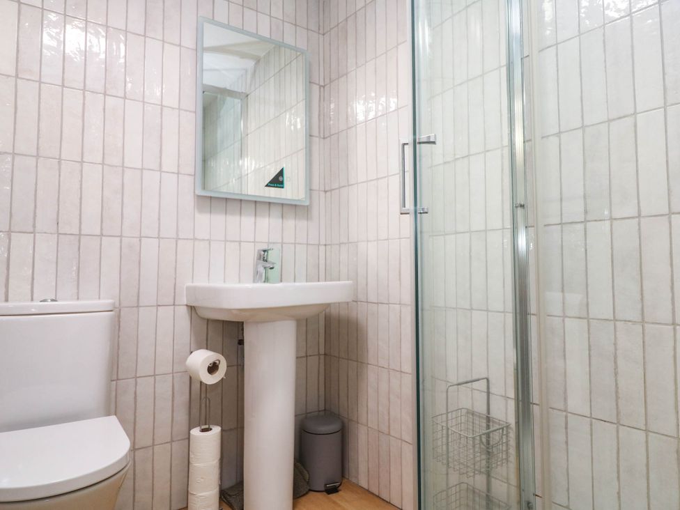 A bathroom with a sink and shower at The Cabin in St Ives