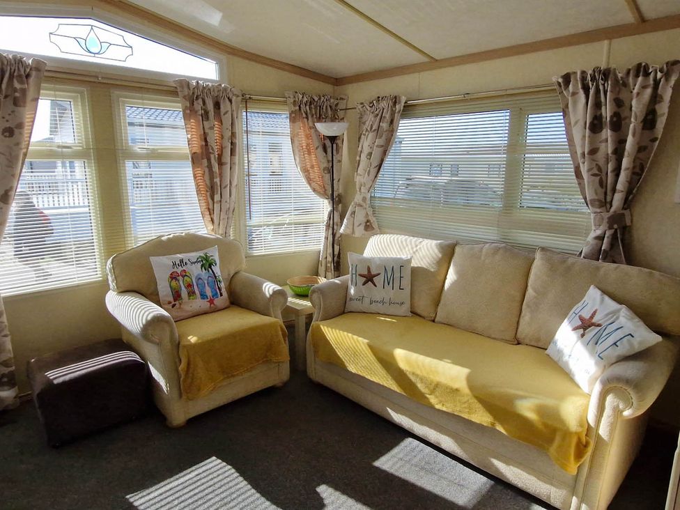 A snug with a couch and armchair in Beachcomber Cabin Dog Friendly Anderby Creek Lincolnshire