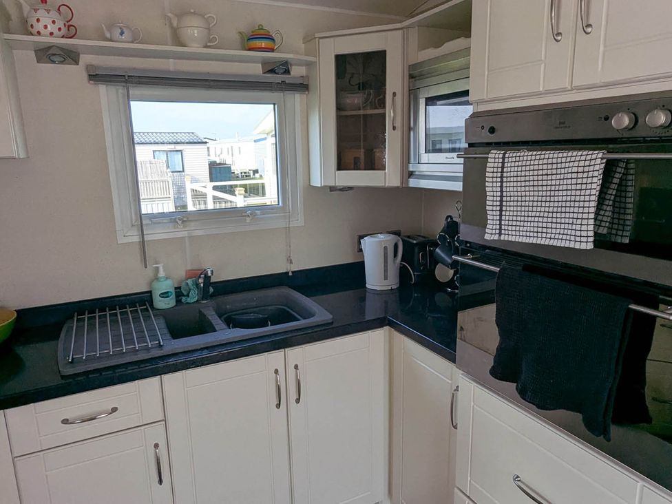 A kitchen with a sink and kettle at Beachcomber Cabin Dog Friendly Anderby Creek Lincolnshire