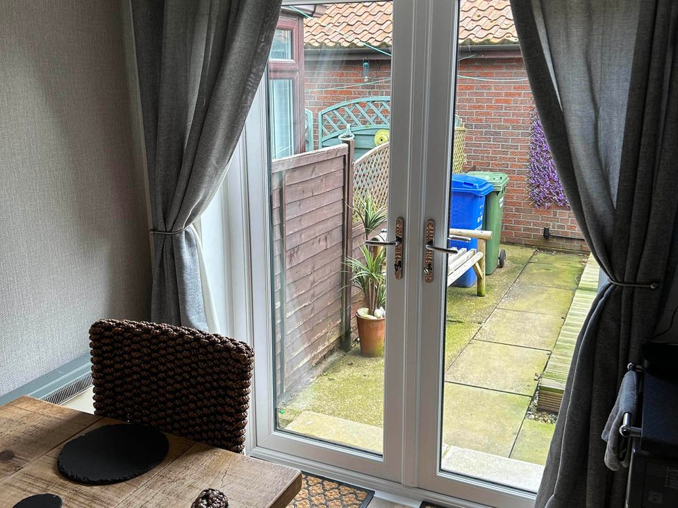 A dining room with a view of the garden at The Old Barn in Manchester