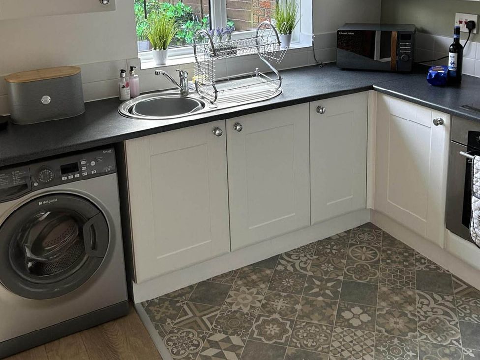 A kitchen with a washing machine and sink at an unspecified location