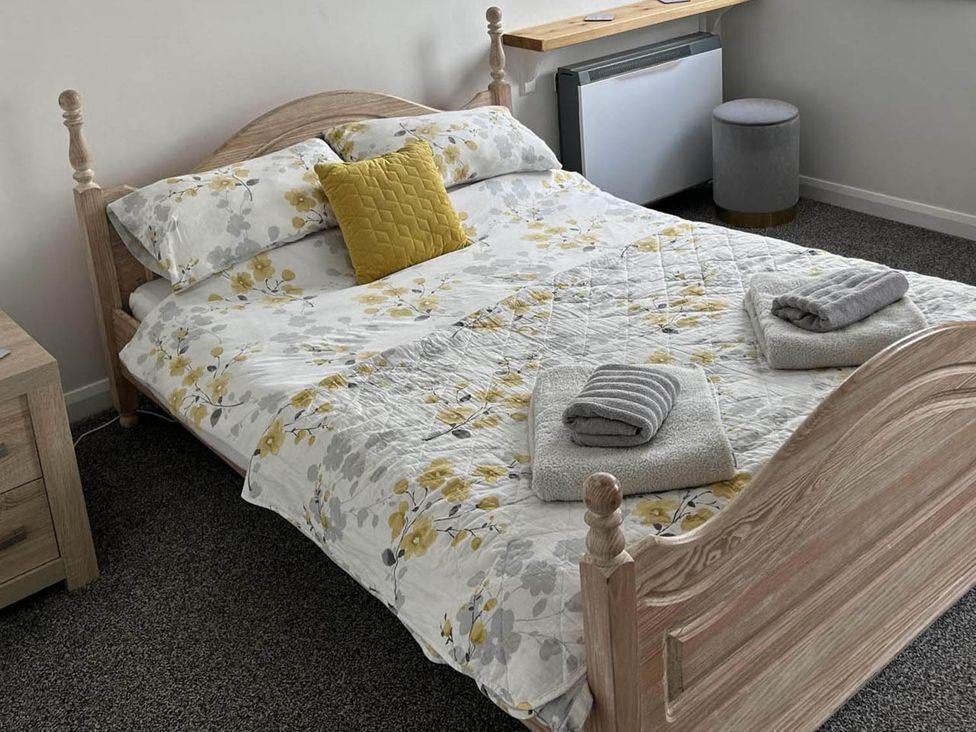 A bed with pillows and towels in a bedroom