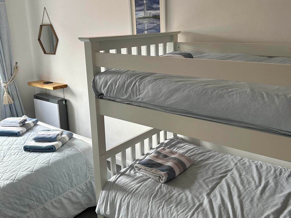 A bedroom with a bunk bed and double bed at The Old Barn in Manchester