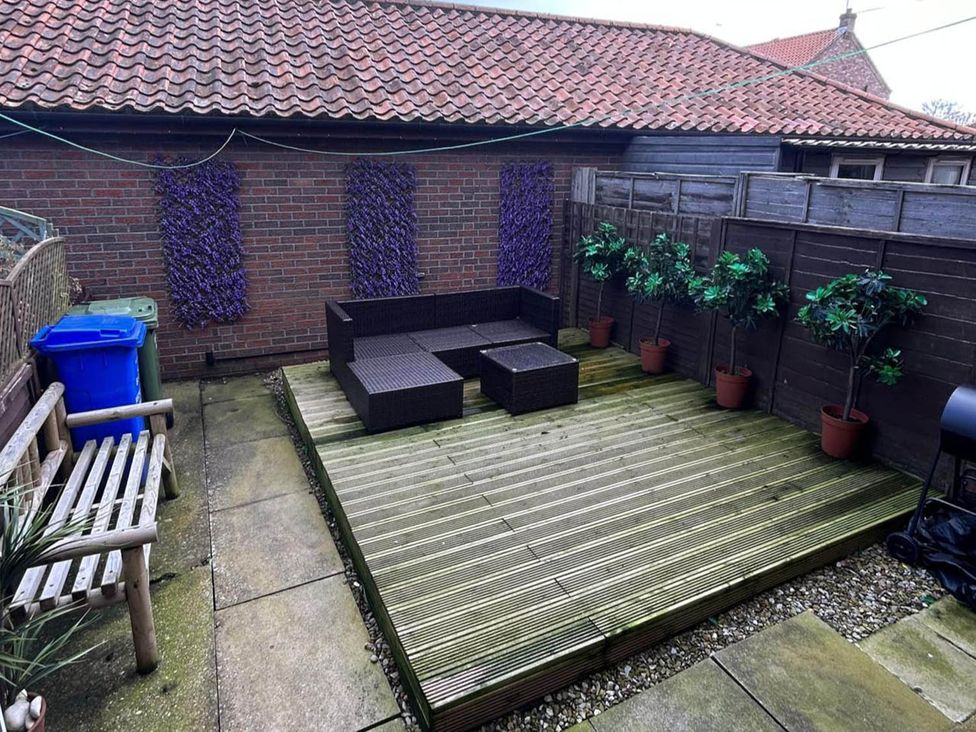 A garden with decking and furniture at the property in the unspecified location