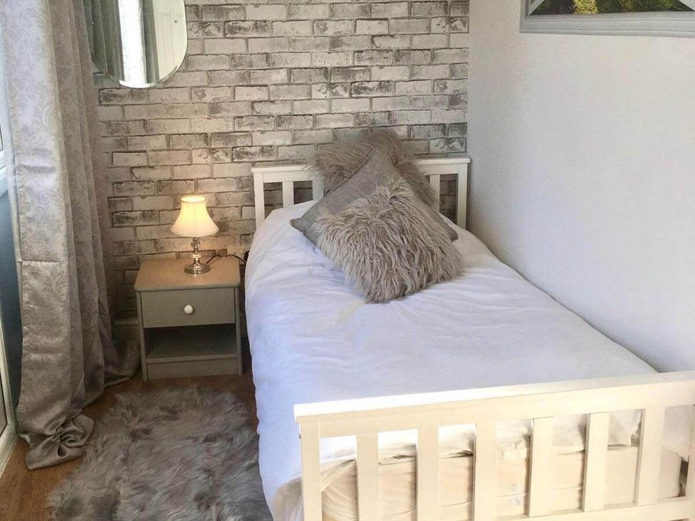 A bedroom with a bed and lamp at the property in location