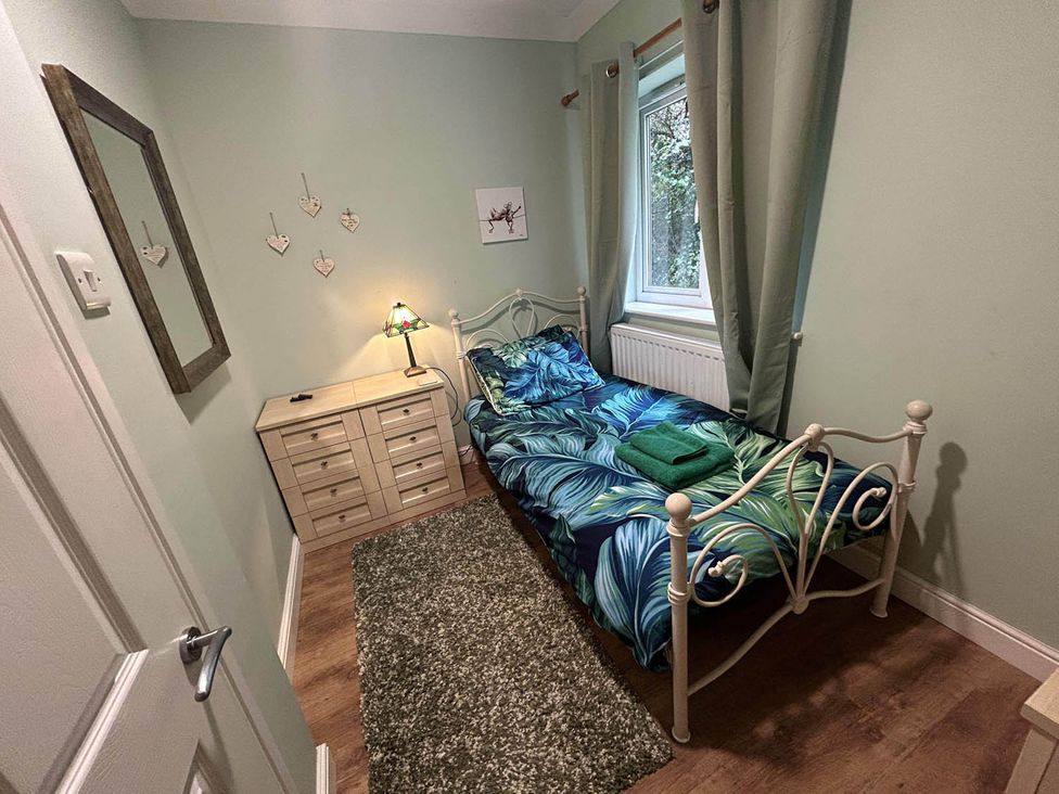 A bedroom with a bed and dresser at the property in unspecified location