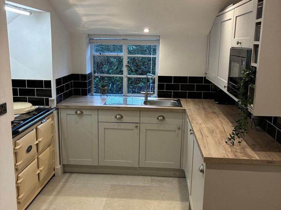 A kitchen with a sink and cabinets at The Old Barn in Manchester