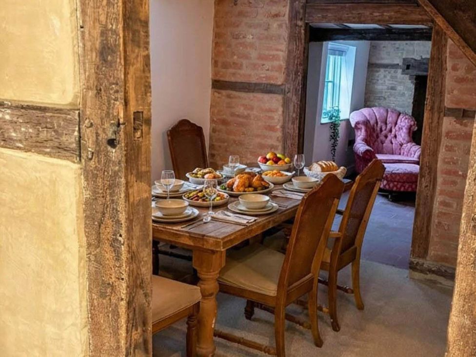 A dining room with a table set for a meal at a property