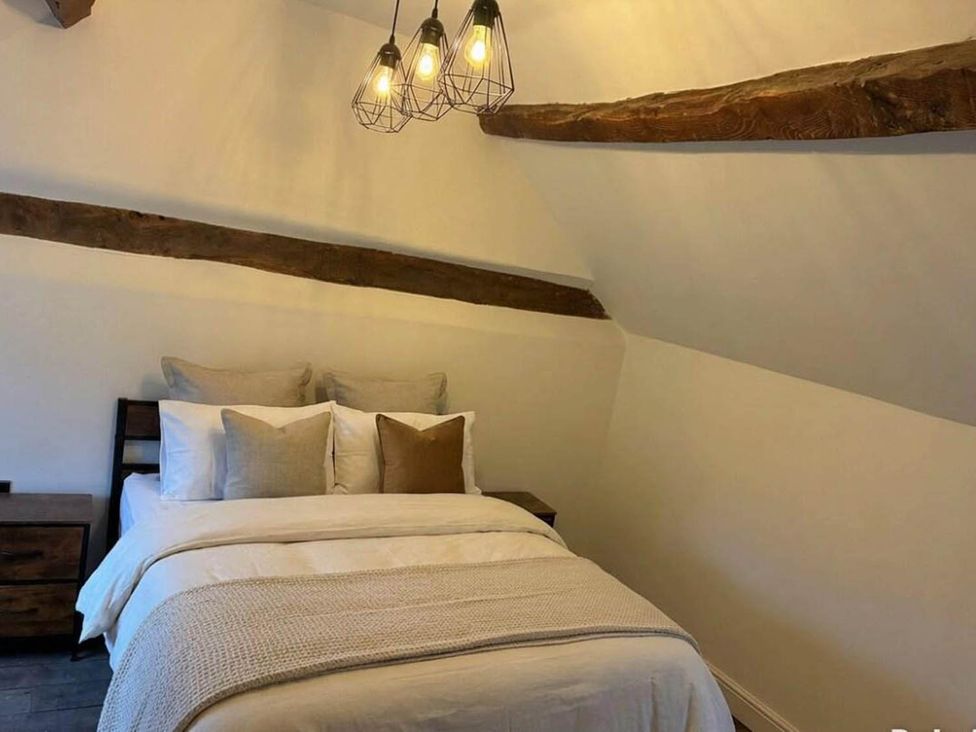 A bedroom with a bed and nightstand at the property