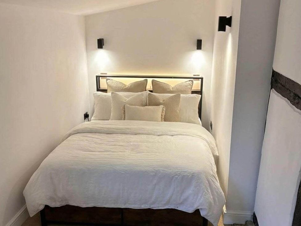 A bedroom with a bed and pillows at The Old Barn in Manchester