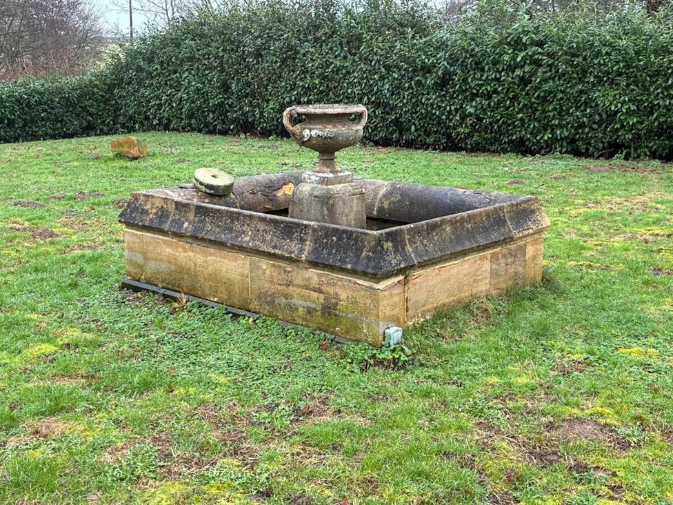 A stone fountain in a garden