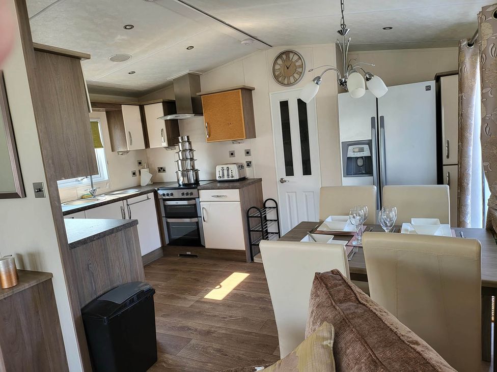 A kitchen with dining table and appliances at the property in 