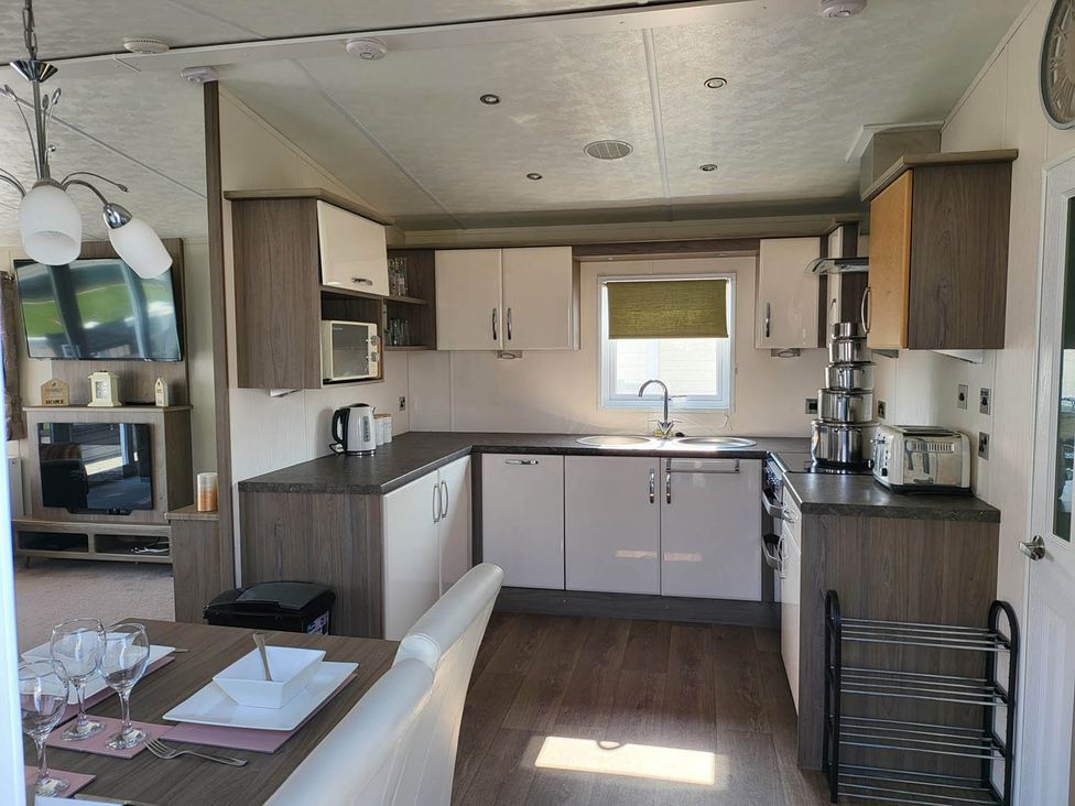 A kitchen with appliances and dining setup at The Old Barn in Manchester