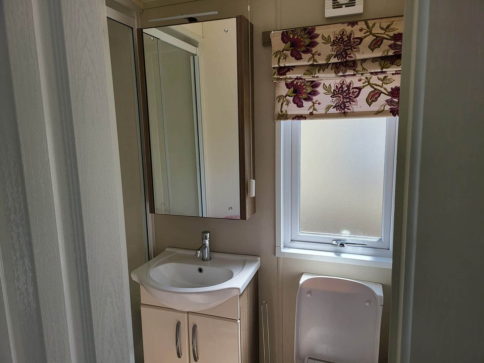 A bathroom with a sink and toilet at 