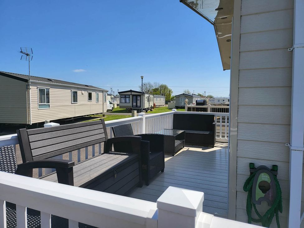 An outdoor area with seating and a view of mobile homes at '' 