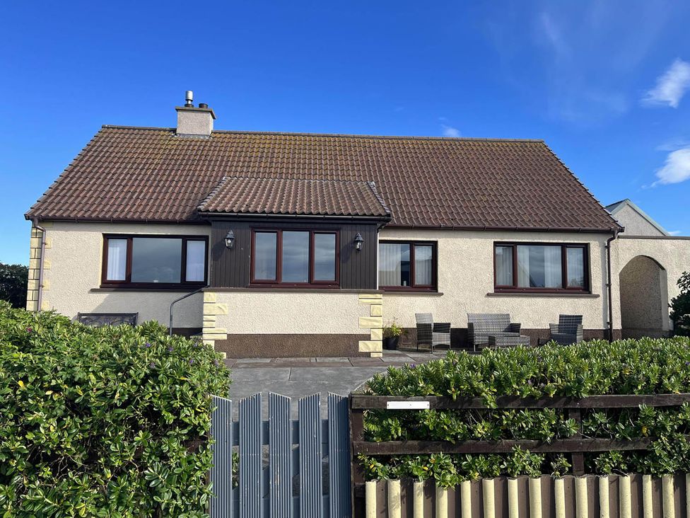 A house with a garden and patio area at 