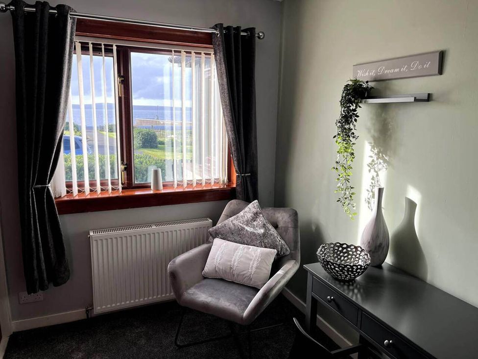 A seating area with a window and decorative items at The Old Barn in Manchester