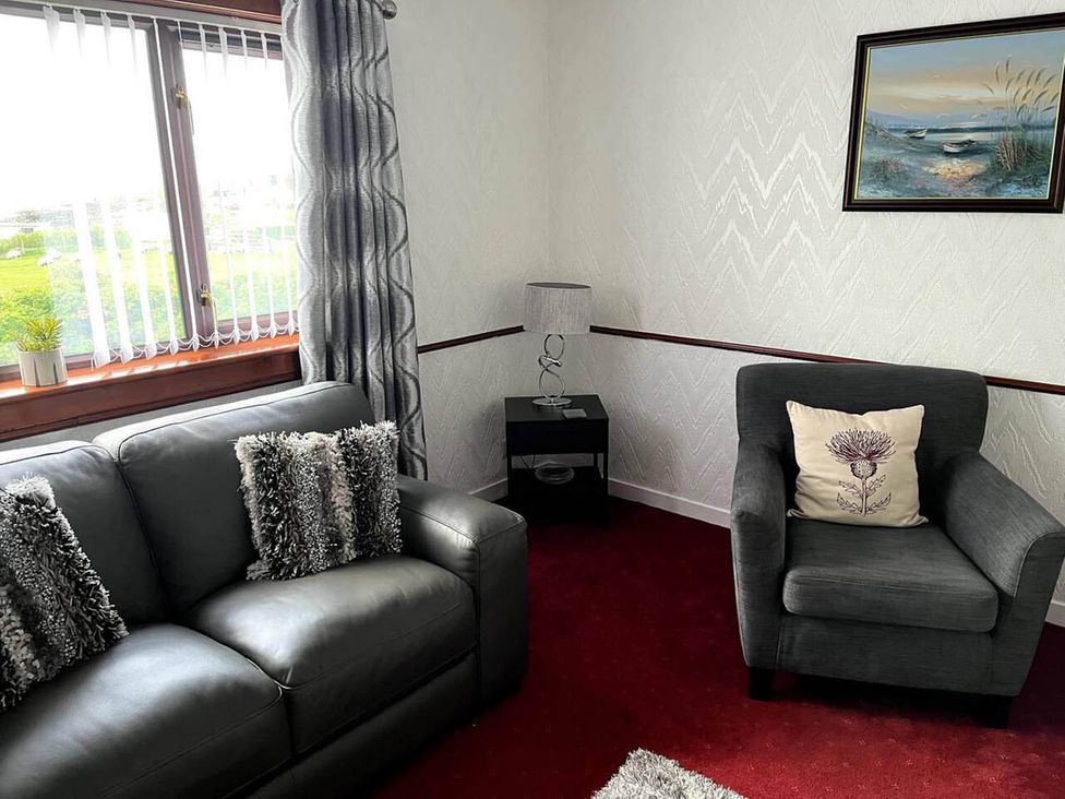 A living room with a sofa and armchair at The Old Barn in Manchester