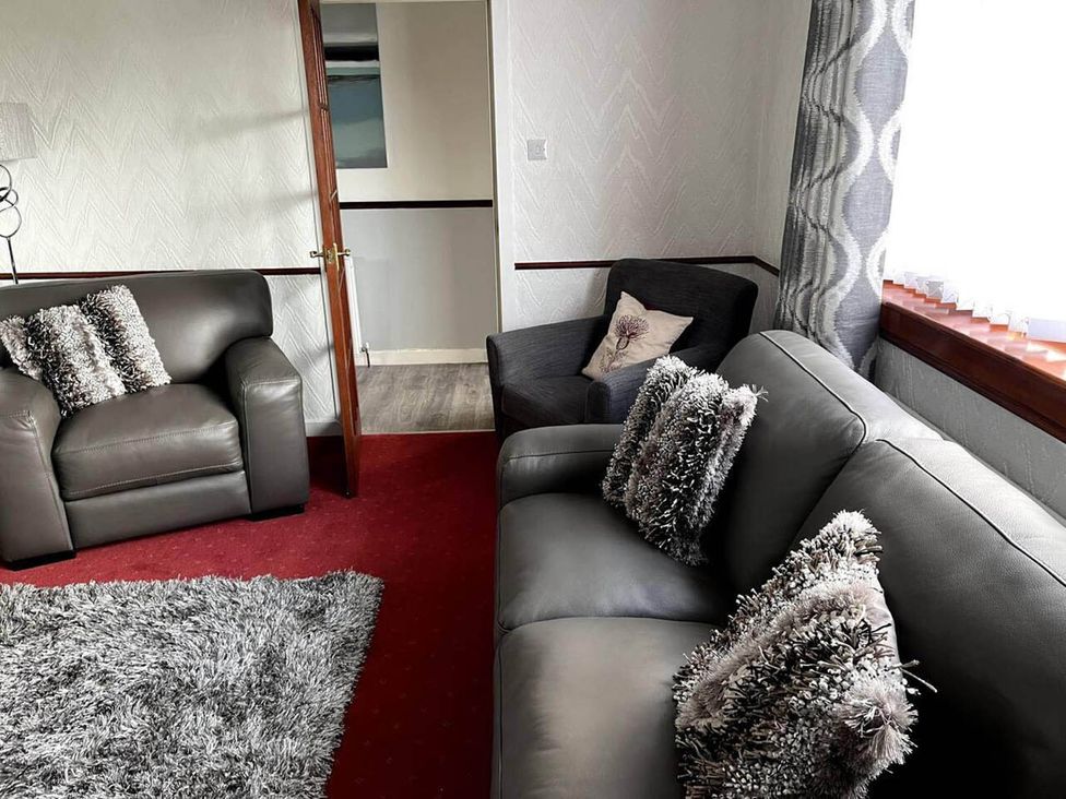 A living room with a sofa and armchair at the property