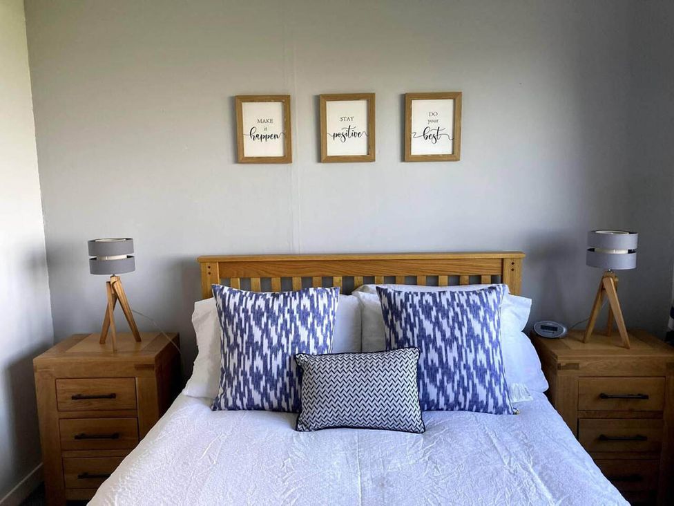 A bedroom with a bed and nightstands at 