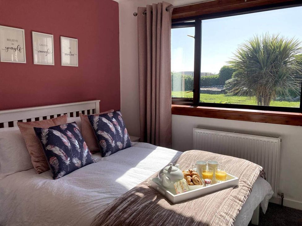 A bedroom with a bed and breakfast tray at an unspecified location