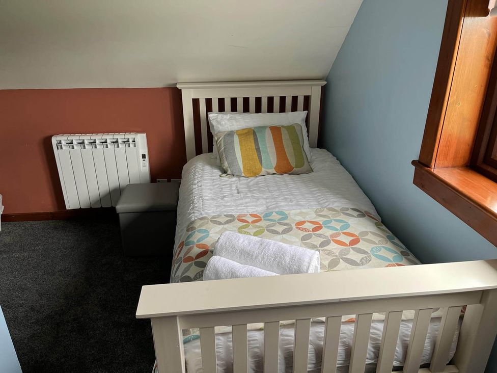 A bedroom with a single bed and a radiator at the property in 