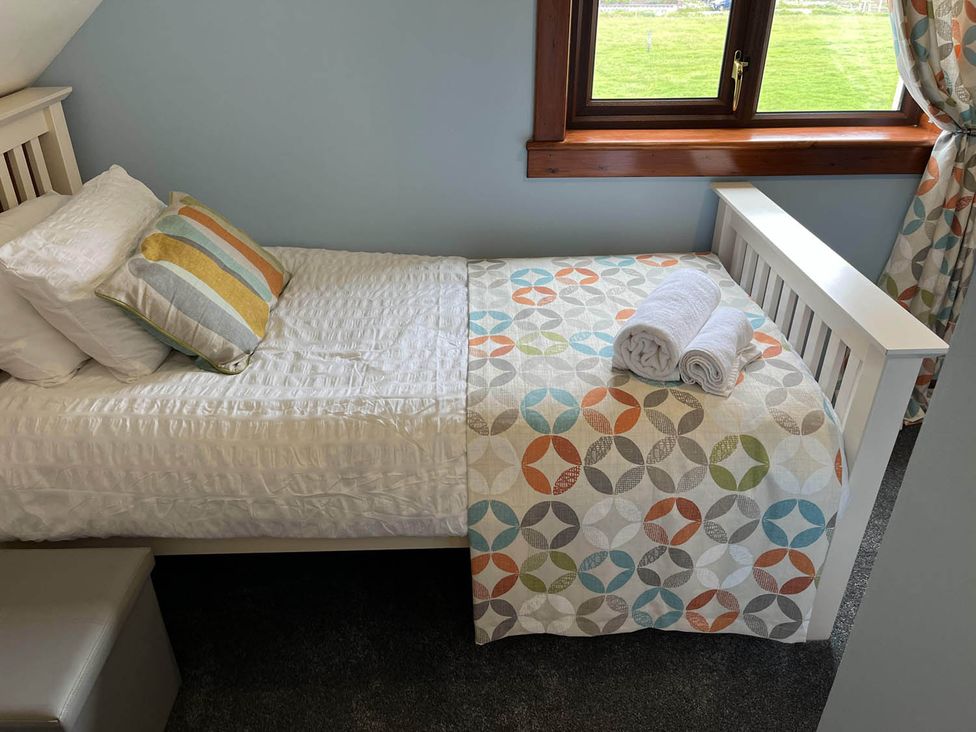 A bedroom with a single bed and towels at the property in an unspecified location