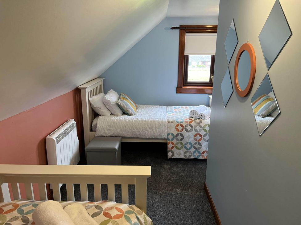 A bedroom with two beds and a mirror at 