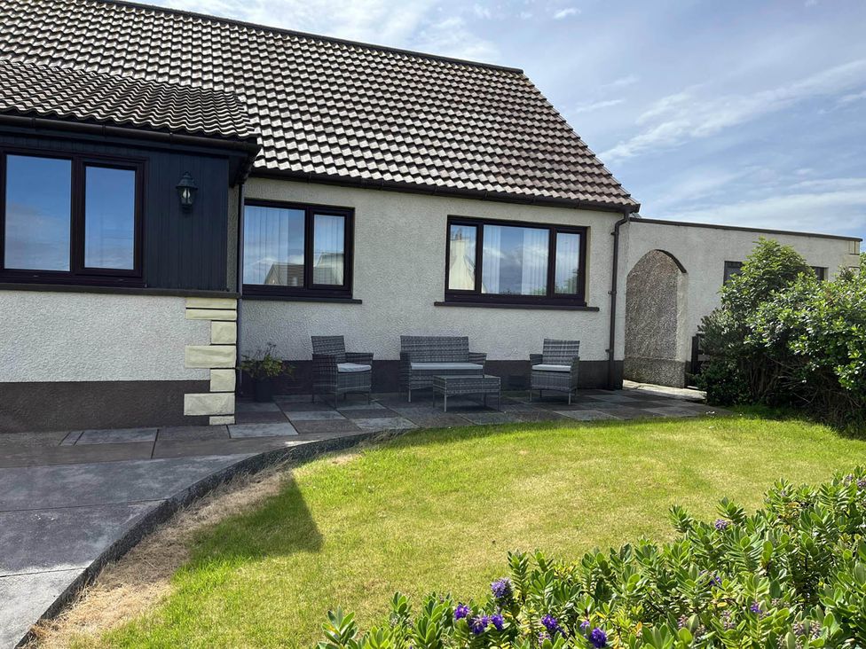 A house with patio furniture and a garden at The Old Barn in Manchester