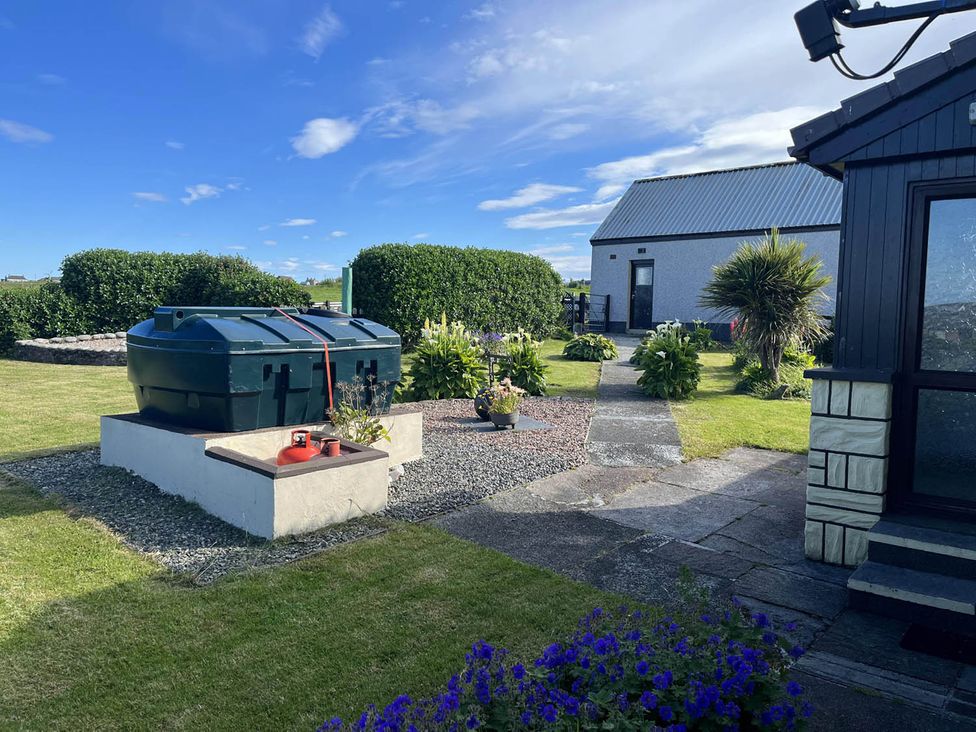 A garden with a hot tub and plants at a property